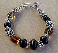 Jet, Amber, and Sterling Silver necklace, bracelet and earrings by Vicky Jousan
